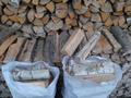 Березовые колотые дрова в мешках
